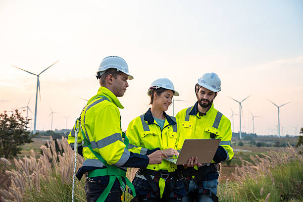 istock Technician and Engineer Working on a Windmill Turbine in the Field, Harnessing Renewable Energy for Sustainable Power Generation, Using Advanced Technology and Innovation to Support the Environmental 2211315625