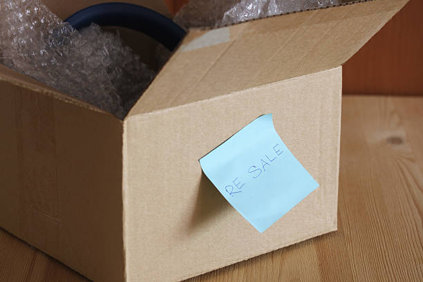 istock Cardboard box with resale label containing steering wheel 2211317861