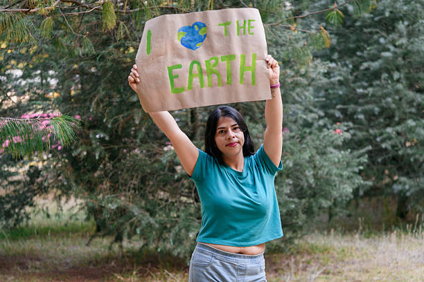 Hispanic latina brunette woman with earth day sign made of craft paper saying: i love earth