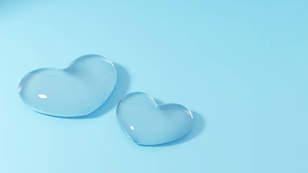 Two translucent, light blue hearts on a soft blue background. Minimalist design conveying love, romance, or affection. Ideal for Valentines Day themes or gentle emotion.