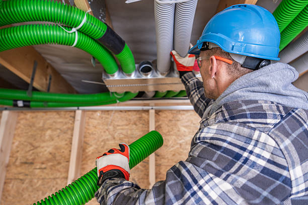 istock Professional Worker Installing Green Ventilation Ducts Indoors 2211322145