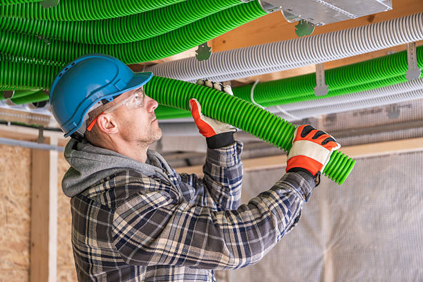 istock Worker Installs Green Tubing in Construction Site Ceiling Area 2211322179