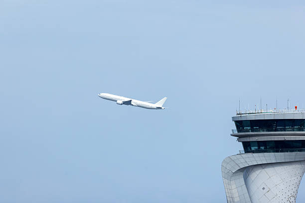 istock Plane is taking off Airport traffic control tower 2211322479