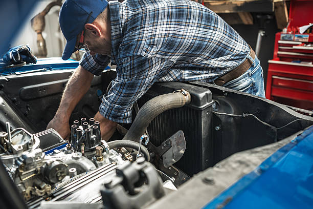istock Mechanic Working on Engine in Garage During Daytime 2211323682