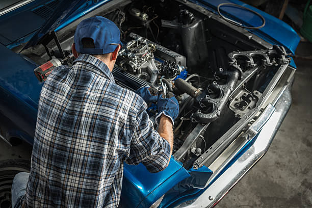 istock Car Mechanic Repairing Engine in Automotive Workshop 2211323737