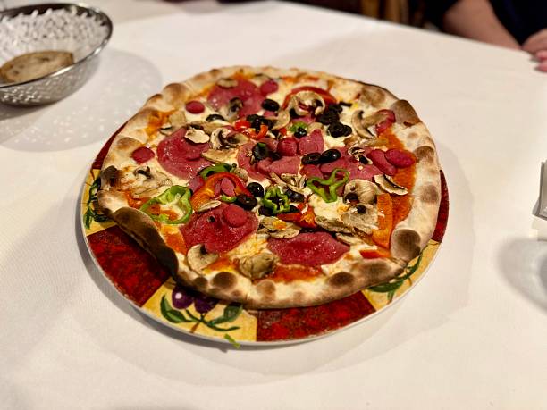istock Italian Pizza served at restaurant on tablecloth ready to eat 2211324222