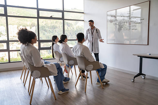 istock Happy doctor teaching a class in medical school 2211325507