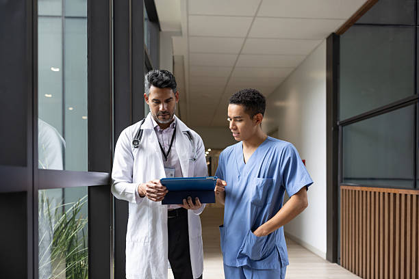 istock Medical student discussing test results with a doctor using a digital tablet 2211325570