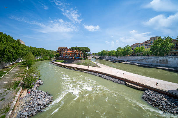 Rome, Lazio, Italy - April 21, 2025: Tiber Island is the smallest inhabited island in the world, the only urban island on the Tiber, about 300 meters long and about 90 meters wide.