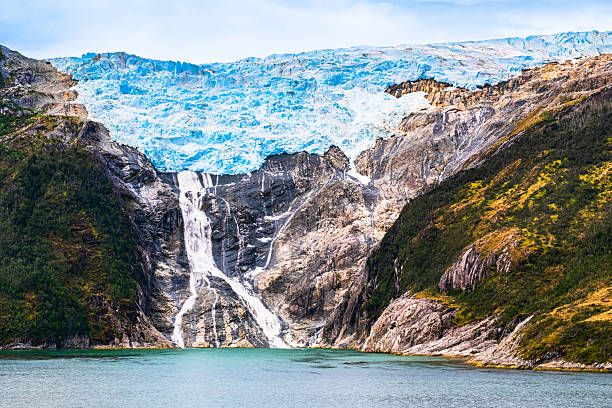 istock Romanche Glacier has a beautiful cascade sliding down into the Beagle Channel.  It is located in Alberto de Agostini NP, Tierra del Frego, Chile. 2211327981