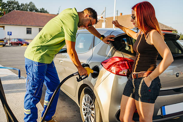 Swiss and traveler people fill oil to tank of car in petrol station at Villages of Tschlin and Ramosch near Samnaun on September 2, 2017 in Graubunden, Switzerland