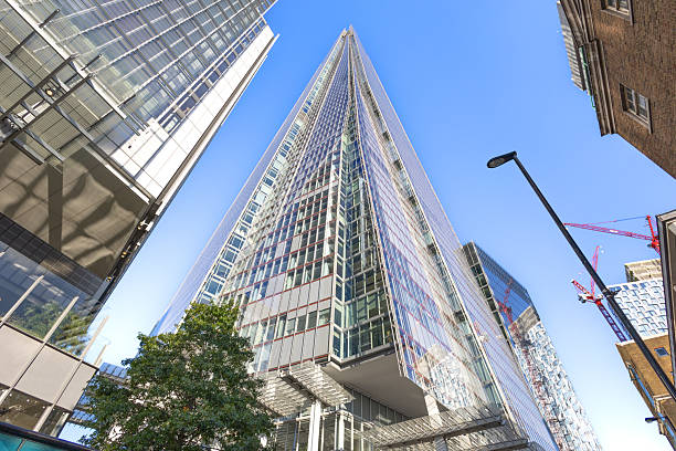 London, UK - May 10 2023: The Scalpel at 52-54 Lime Street. This tall and pointed London skyscraper is framed by other tall buildings, St Helen's (left) and The Cheesegrater (right).