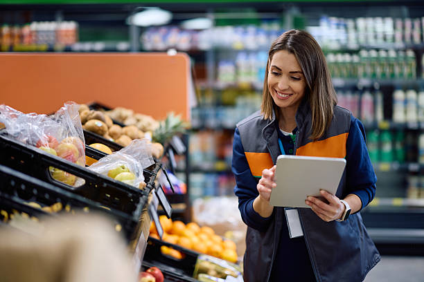 istock Supermarket employee working on touchpad at fresh food section. 2211334997