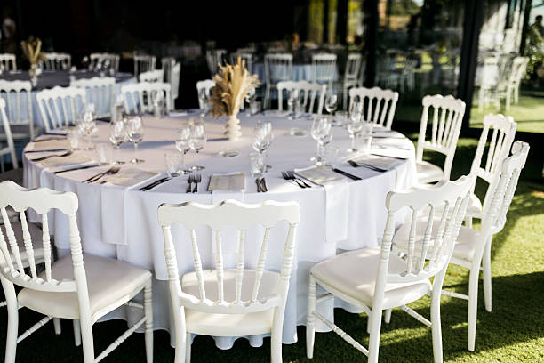 The table is elegantly set for an event with a blank place card, cutlery, and glassware arranged beautifully