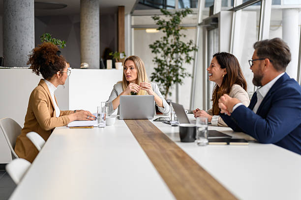 istock Professionals sharing ideas and discussing strategies while working on a new project in board room 2211336341