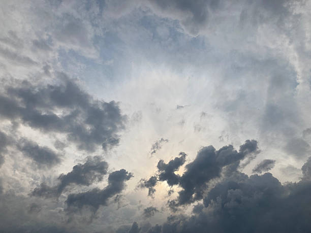 istock A dramatic, stormy sky scene with sunlight piercing through dark gray clouds from the top left corner The image emphasizes vastness and power of nature 2211343265
