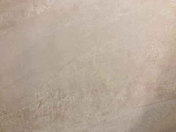 istock Close-up image of a textured stone or concrete surface, with natural color variations and a sense of depth from an angled view The focus is on the texture and play of light 2211343308