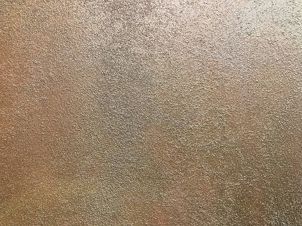 istock Close-up image of a textured surface, possibly metallic Rough texture with small dots or specks Color gradient from dark top left to light bottom right Organic pattern, macro shot, potentially par 2211343309