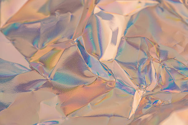 istock An abstract, iridescent textured surface resembling shattered glass or metallic glint, transitioning from warm to cool hues, suitable for luxury, fragility, or digital transformation marketing 2211346139