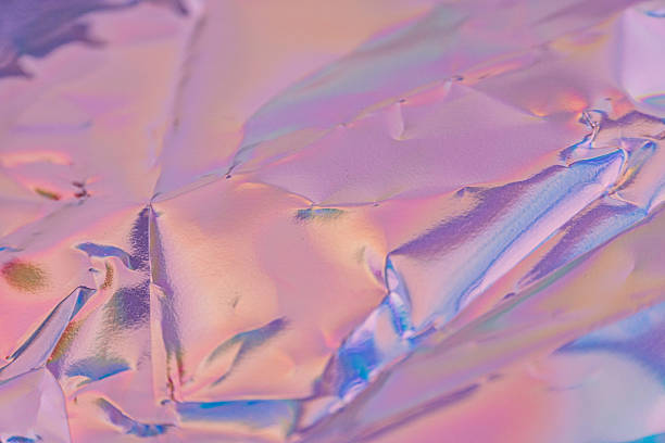 istock Close-up of iridescent foil with shimmering, multi-colored surface could be used for decorative purposes or packaging 2211346148