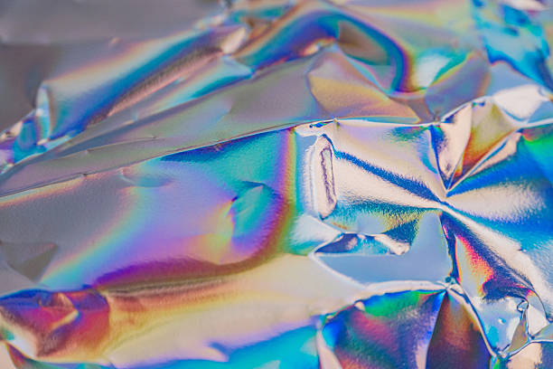 istock Image showcases iridescent foil with a vibrant color spectrum, suggesting high-end or luxurious quality, suitable for premium products such as cosmetics, jewelry packaging, and luxury goods 2211346151