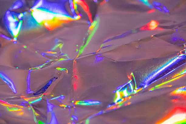 Image shows a colorful shattered glass pattern, representing themes like disruption, fragility, or spectrum of light from broken surfaces