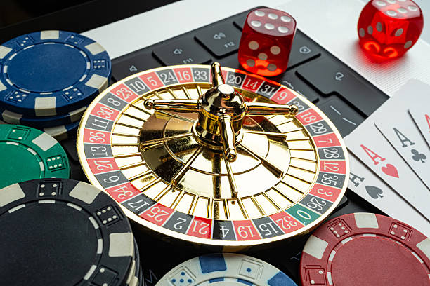 istock A vibrant, intricate roulette wheel with scattered playing cards on a richly textured surface, suggesting gambling and luxury Suitable for marketing materials related to casinos, gaming resorts, or 2211346233