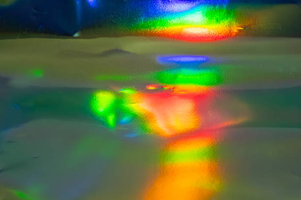 Abstract scene with vibrant colors, dynamic color interplay, symbolizing diversity or energy, reflective glossy surface, potentially wet, used for marketing materials due to aesthetic appeal and vers
