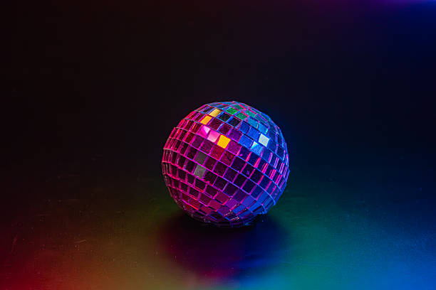 istock A disco ball casting colorful lights in a retro party environment 2211346347