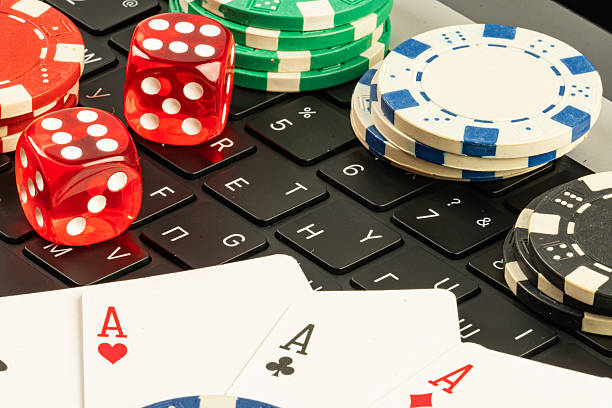 istock Staged image depicting gaming elements like playing cards, casino chips, and computer keyboard, symbolizing luck, risk, and excitement in gambling experiences Las Vegas or online 2211346514
