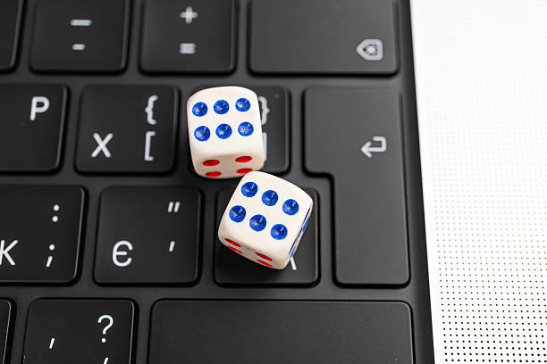 istock A laptop keyboard holds two numbered dice suggesting a tech-related decision or randomness in marketingadvertising strategies 2211346517