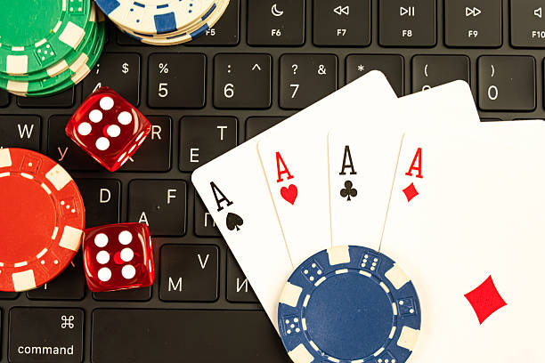 istock Image features gambling-related objects, including poker cards, dice, a roulette wheel, and chips, possibly depicting online or virtual casino games 2211346554