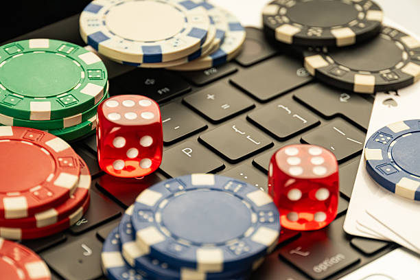 istock Image shows poker chips and dice against a black backdrop, suggesting a gaming or gambling theme 2211346562