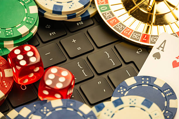 istock High-resolution composite image of casino chips, closed laptop, moving roulette wheels, playing cards ace of spades, ace of hearts, and designed for marketing in gambling or gaming services 2211346621
