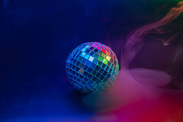 istock Image showcases a disco ball amidst transitioning light and color, suggesting a party or celebration atmosphere The disco ball reflects colors, creating a glamorous, nostalgic scene Potential use i 2211346701