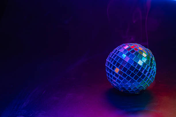 istock A disco ball reflects vibrant colors against a dark backdrop, illuminated by a purple light source Symbolizes fun, celebration, and possibly the 1970s disco culture 2211346763