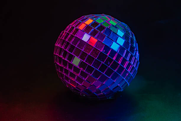 istock Image of a disco ball against a dark background, reflecting colored dots due to surrounding light sources Connotes fun and festive atmosphere associated with parties 2211346781