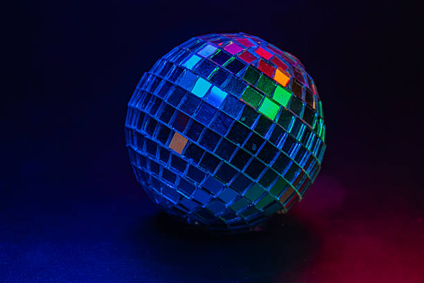 istock Disco ball illuminated in dark space, creating a sparkling effect like stars Evokes fun, celebration or nostalgia for retro dance culture 2211346796