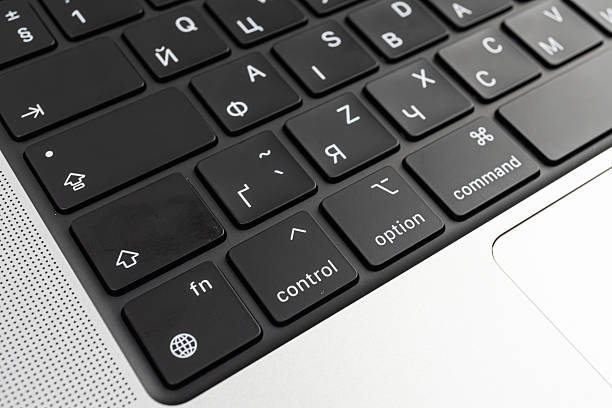 A high-resolution close-up of a modern, multi-language keyboard on a laptop, showcasing ergonomic design and functional keys