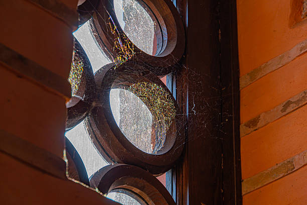istock A traditional stained glass window with intricate circular patterns and wavy lines, casting shadows and highlights, symbolizing tranquility and historical elegance 2211346810