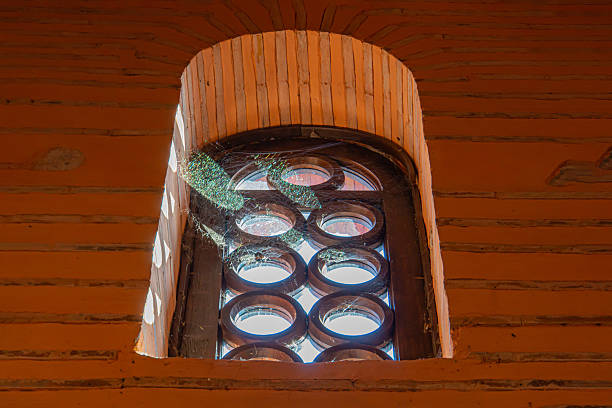 istock Image of a traditional red brick building with an arched window, bathed in warm sunlight 2211346867