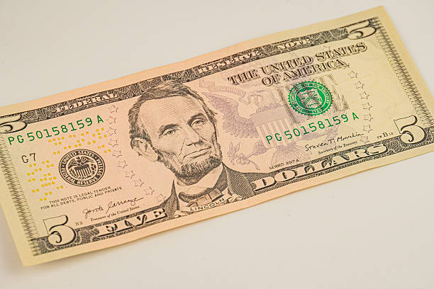 istock Close-up photograph of a five-dollar bill, featuring Abraham Lincoln Sharp focus, natural light, symbolizing value or financial themes 2211346923