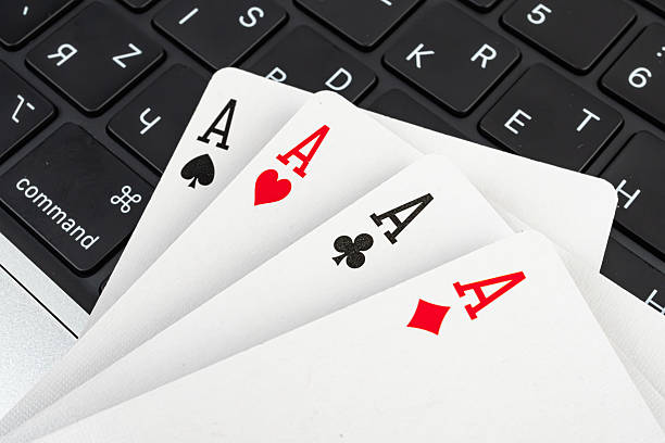 istock Image features a stack of playing cards near a computer keyboard, suggesting gaming or technology contexts with a playful or risk-taking vibe 2211346960