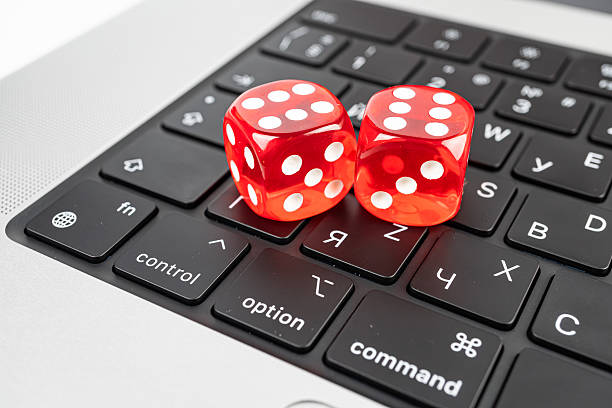 istock A pair of red dice rests on a computer keyboard, symbolizing chance, risk, and unpredictability in digital realms 2211347037