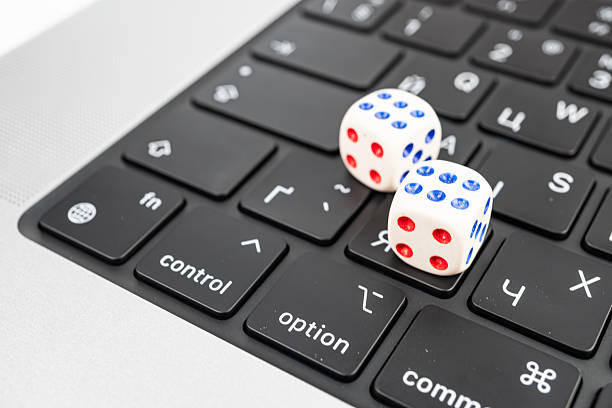 istock Close-up of two dice on a keyboard symbolizing technology-related chance or randomness 2211347055