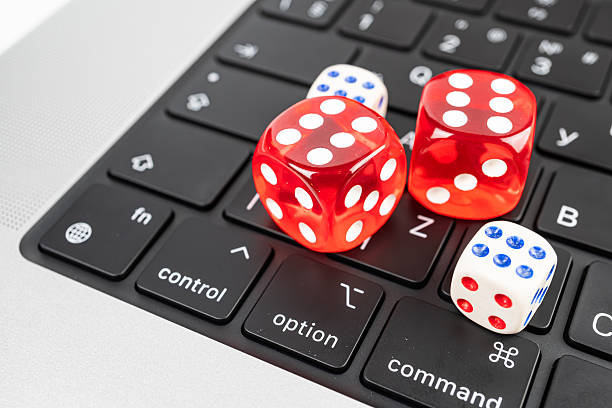 istock Three colorful dice on a computer keyboard with dots from 1 to 6 Scene suitable for technology, gambling, games, or decision-making marketingadvertising 2211347069