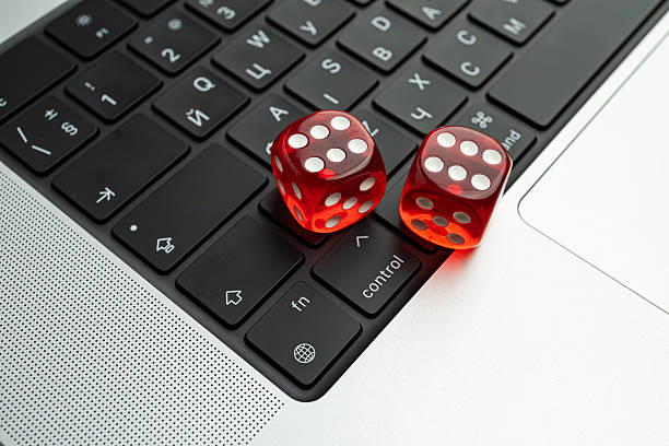 istock A staged photo of two numbered dice on a laptop keyboard, symbolizing randomness or decision-making in the context of technology 2211347100