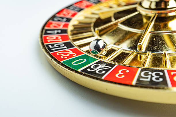 istock Image features a spinning roulette wheel, with a blurred metal ball, numbered betting areas in red and black, a green 0 pocket, white-marked additional betting options Background is non-descript 2211347110