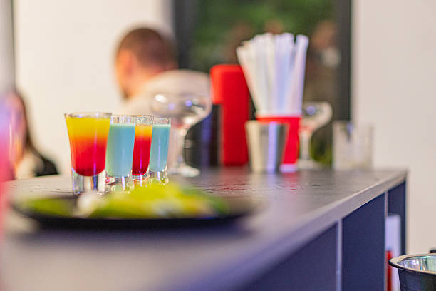 istock A vibrant, bustling bar setting featuring colorful cocktails in various glassware and a bartender serving drinks amidst blurred patrons enjoying the inviting ambiance Ideal for marketing materials p 2211348041