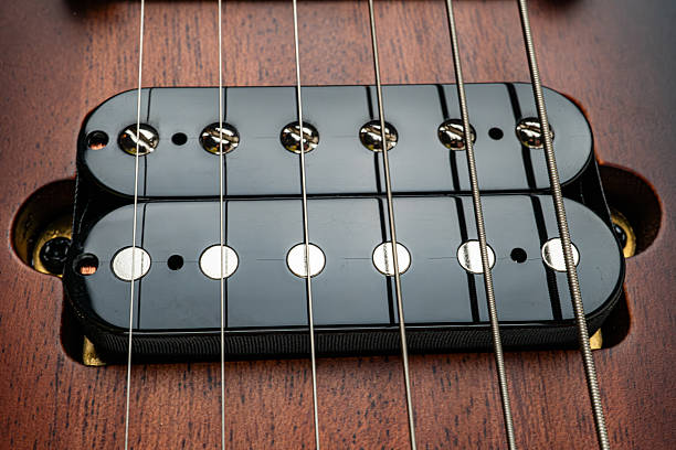 istock A close-up image showcases the precision and design of a guitar bridge, highlighting its gleaming strings contrasting with warm wood tones It underscores the craftsmanship involved in these musical 2211348165